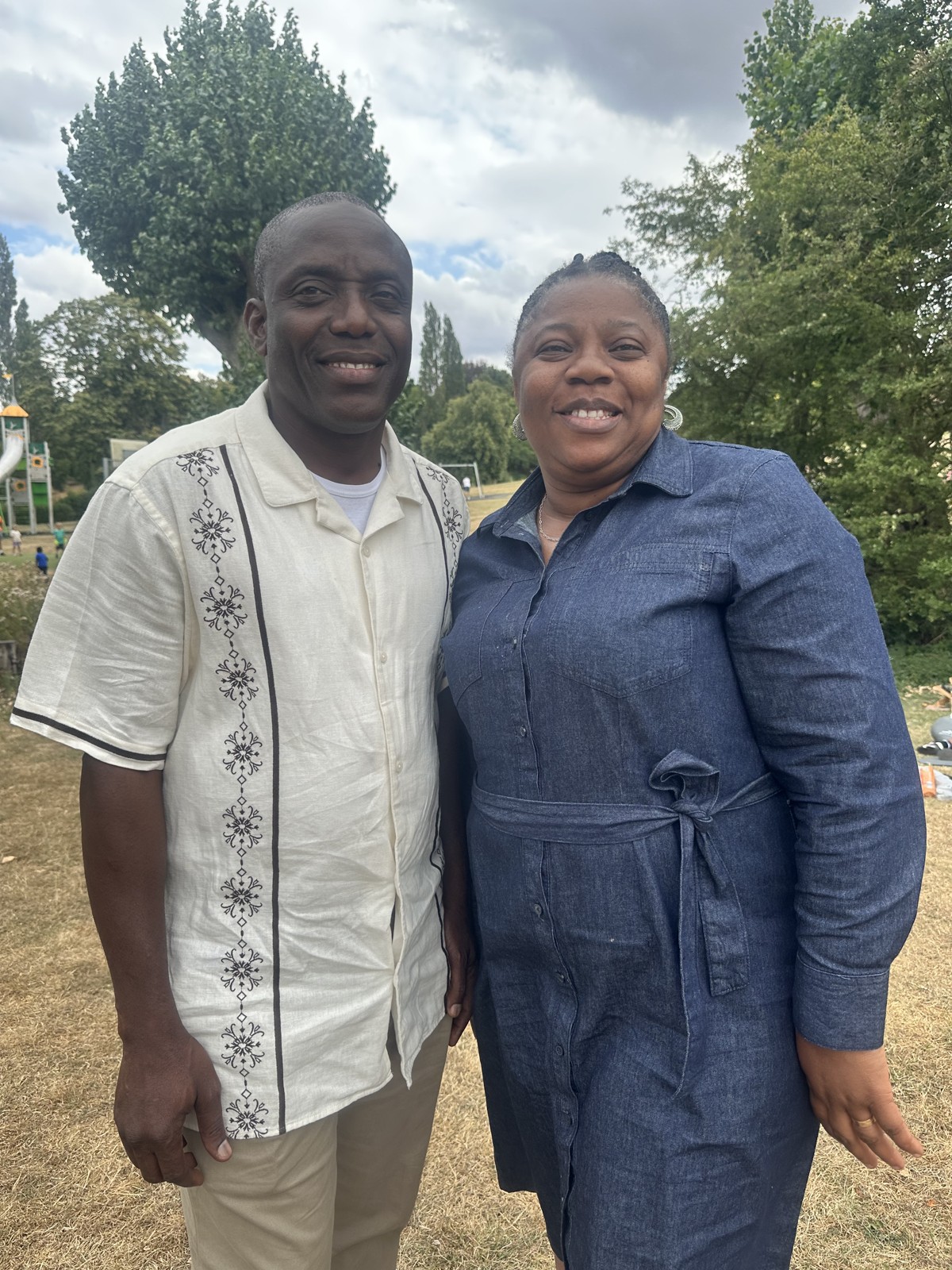 A couple from the church family smiling in the park